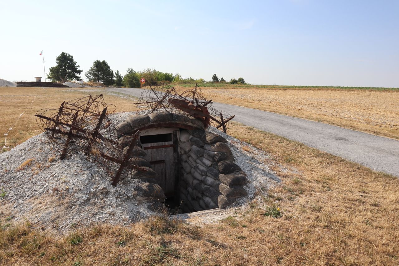 Historic WWI bunker entrance with barbed wire at Massiges, France.
