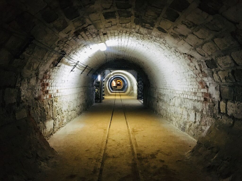 Explore the eerie atmosphere of a dimly lit underground tunnel, perfect for mystery or adventure themes.