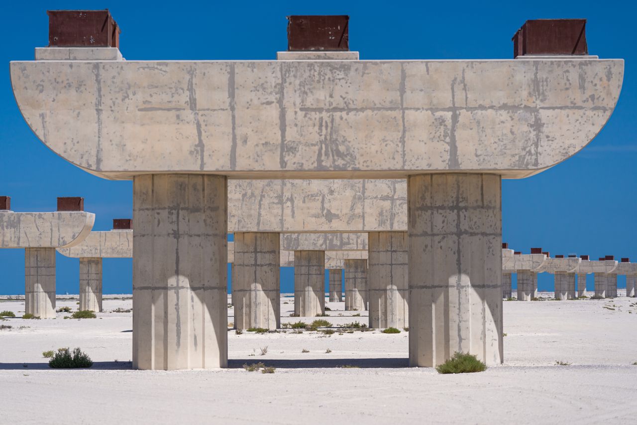 Abstract image of unfinished concrete structures in Dubai desert setting.